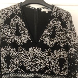 Beautiful lacy top for special occasion. Black with white lacy detailing.
